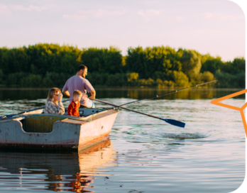 A father in a row boat with his two kids